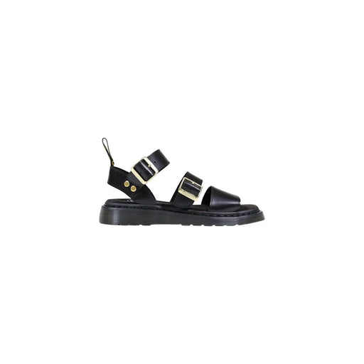 Sandales Dr. Martens pour femme en cuir noir avec boucles dorées et semelle épaisse en caoutchouc visible à l'arrière