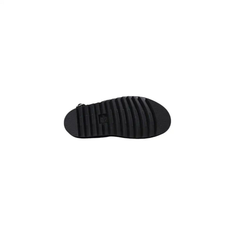 Black rubber sole with textured ribbed pattern and small logo near the heel of dr martens women black leather sandals with buckle