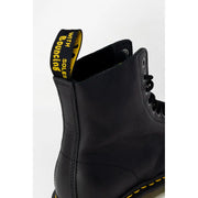 Black leather ankle boots for women by dr martens shown from the back side featuring sturdy design and classic style