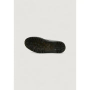 Black rubber sole with deep tread pattern and embossed dr martens logo on women’s black leather ankle boots for fall winter