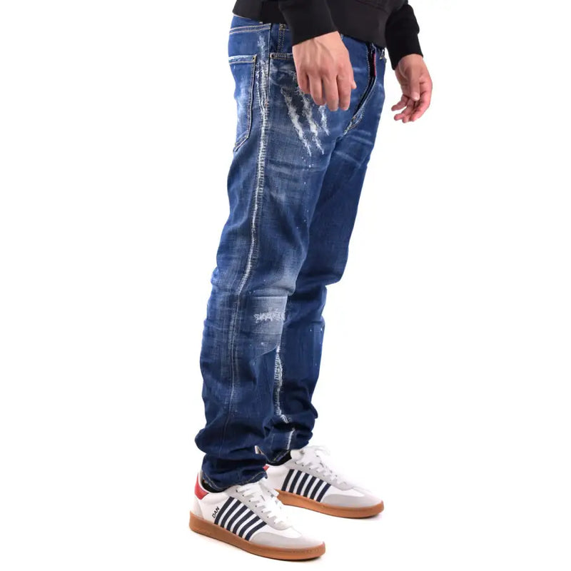 Blue distressed denim jeans with white adidas sneakers and black shirt.