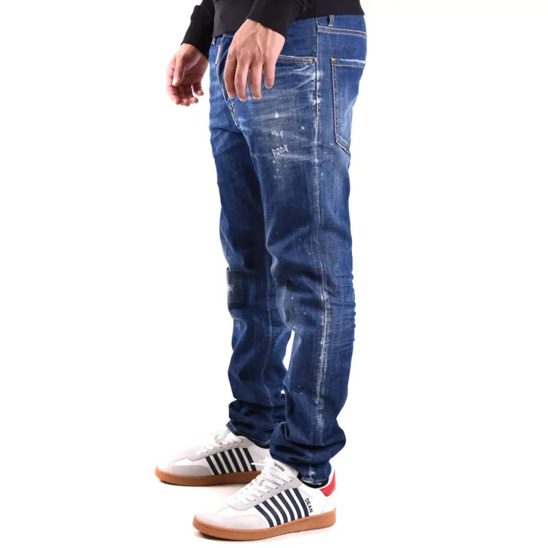 Jean homme Dsquared2 bleu délavé, coupe slim, en coton et élasthanne, avec effet usé et détails effilochés.