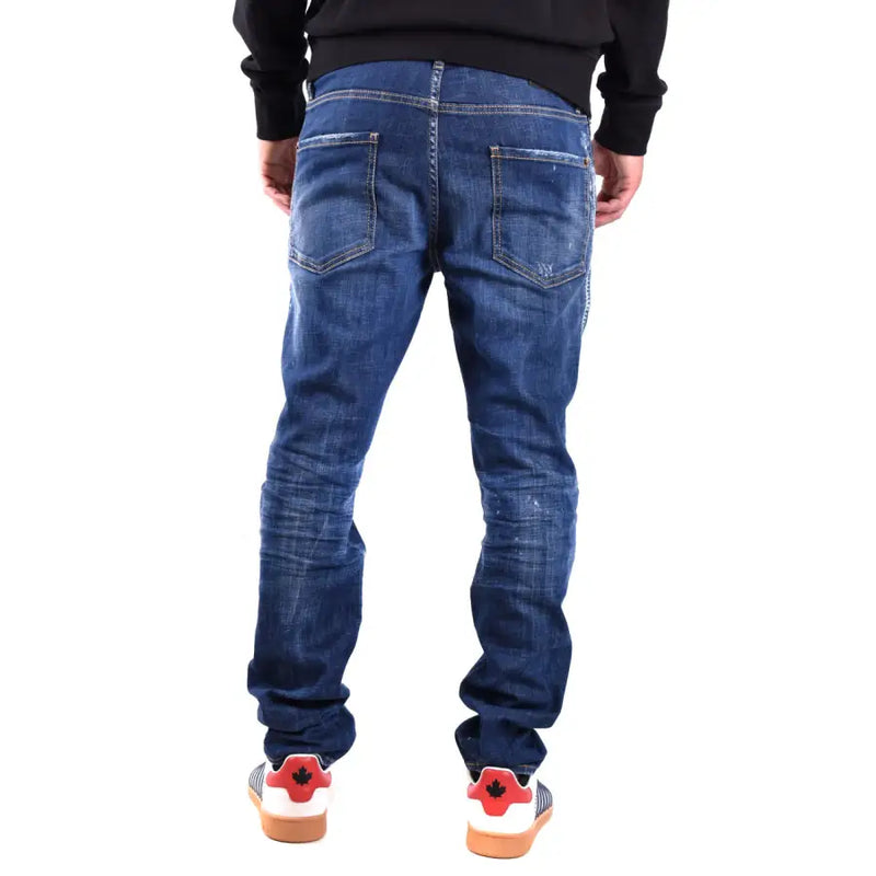 Jean slim bleu foncé Dsquared2 pour homme, en coton élasthanne, avec un effet usé subtil et des détails déchirés.