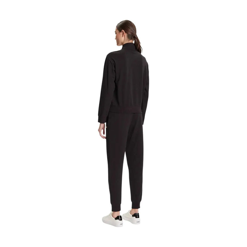 Ea7 Combinaison pantalon noire en coton pour femme, col roulé, manches longues, poignets côtelés et pantalon de jogging assorti (vue de face)