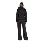 Ea7 Ensemble combinaison pantalon à capuche zippée en coton noir pour femme, comprenant un sweat-shirt et un pantalon à jambes larges (vue de face).