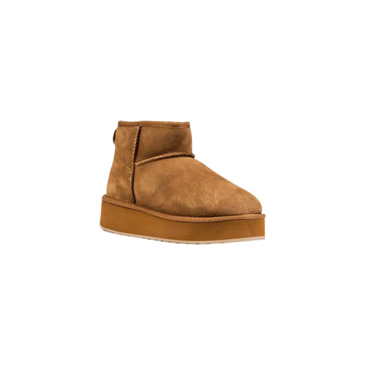 Bottines en cuir beige pour femmes Emu Australia, doublées de daim marron clair et dotées d'une semelle plateforme épaisse visible à l'arrière.