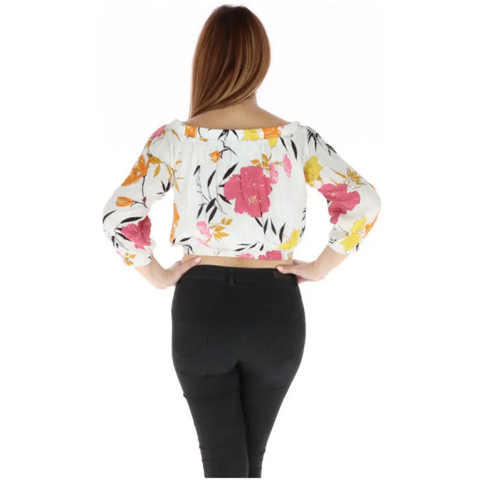 Floral off-the-shoulder crop top paired with black pants for stylish summer attire