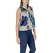 Floral sleeveless green blouse paired with navy pants in a stylish ensemble