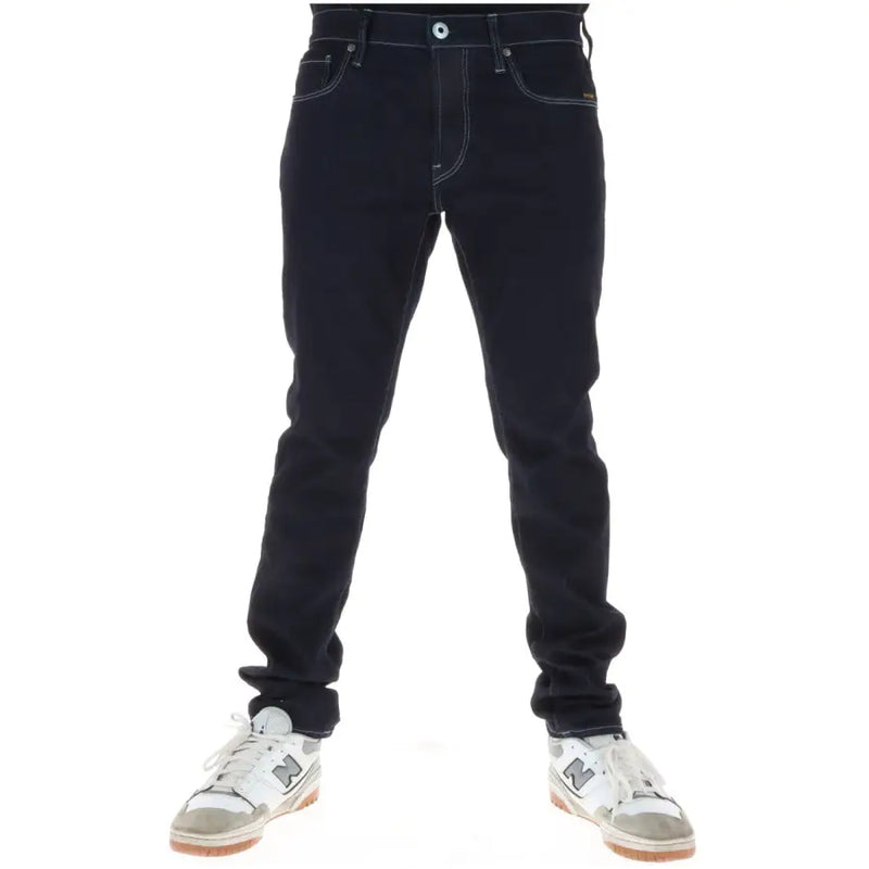 Jean G-Star pour homme en coton stretch indigo foncé, avec surpiqûres blanches contrastantes et braguette boutonnée à cinq poches classiques.