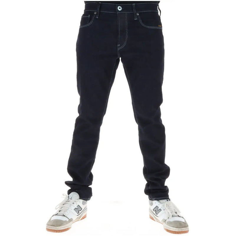 Dark indigo cotton stretch G-star men jeans with contrasting white stitching and classic five-pocket design button fly