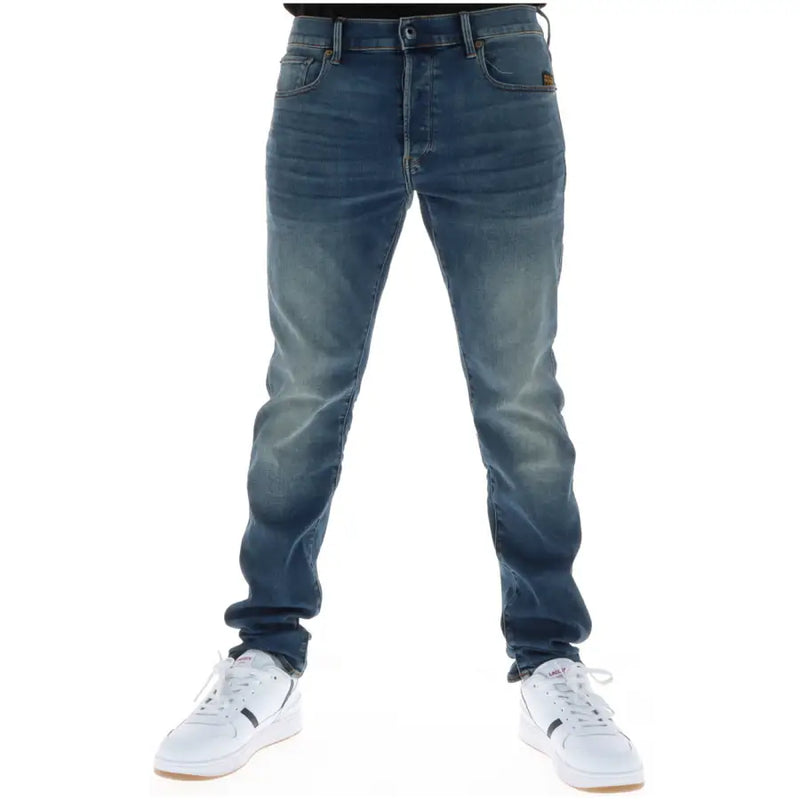 Jean G-Star homme 51001, coupe slim, en denim brut, braguette boutonnée, doublure en coton stretch et étiquette marron.