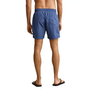 Blue Gant men swimwear swim trunks with elastic waistband and single back pocket shown from the back side