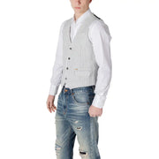 White pinstripe wool vest with button closure and distressed denim jeans.