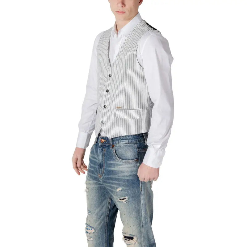 White pinstripe wool vest with button closure and distressed denim jeans.