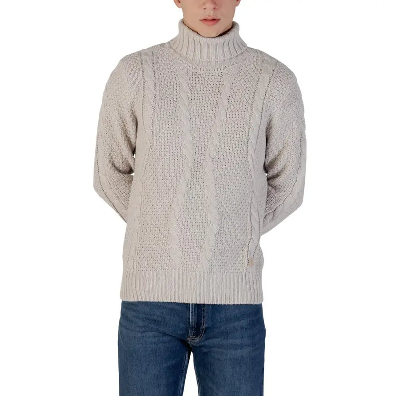 Cream cable knit turtleneck sweater with ribbed detailing and a high neck.