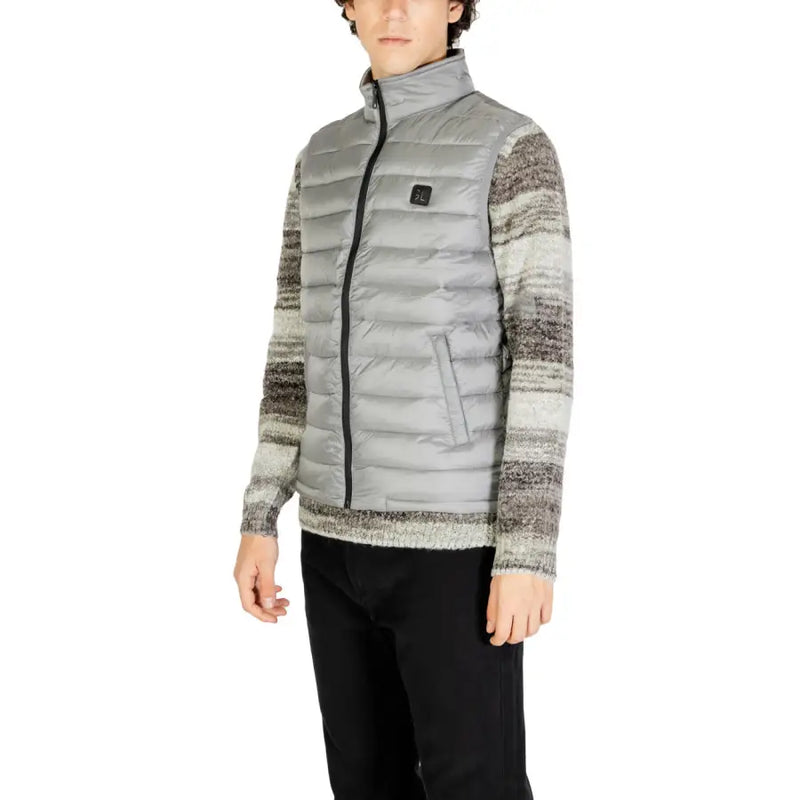 Gray and white striped down jacket with zipper closure.