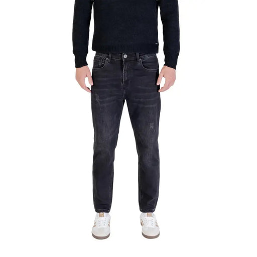 Dark wash slim fit jeans with distressed details and a popular brand logo on the left thigh.