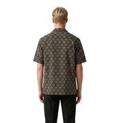 A man wearing a Gianni Lupo men shirt in dark brown with an intricate beige geometric pattern and short sleeves