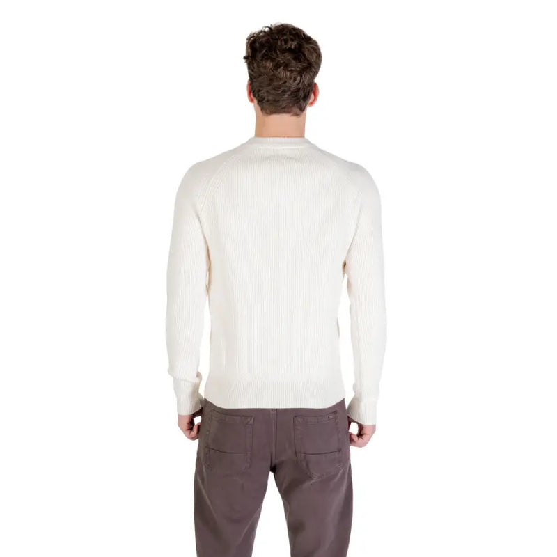 Cream-colored crew neck sweater with ribbed detailing and a relaxed fit.