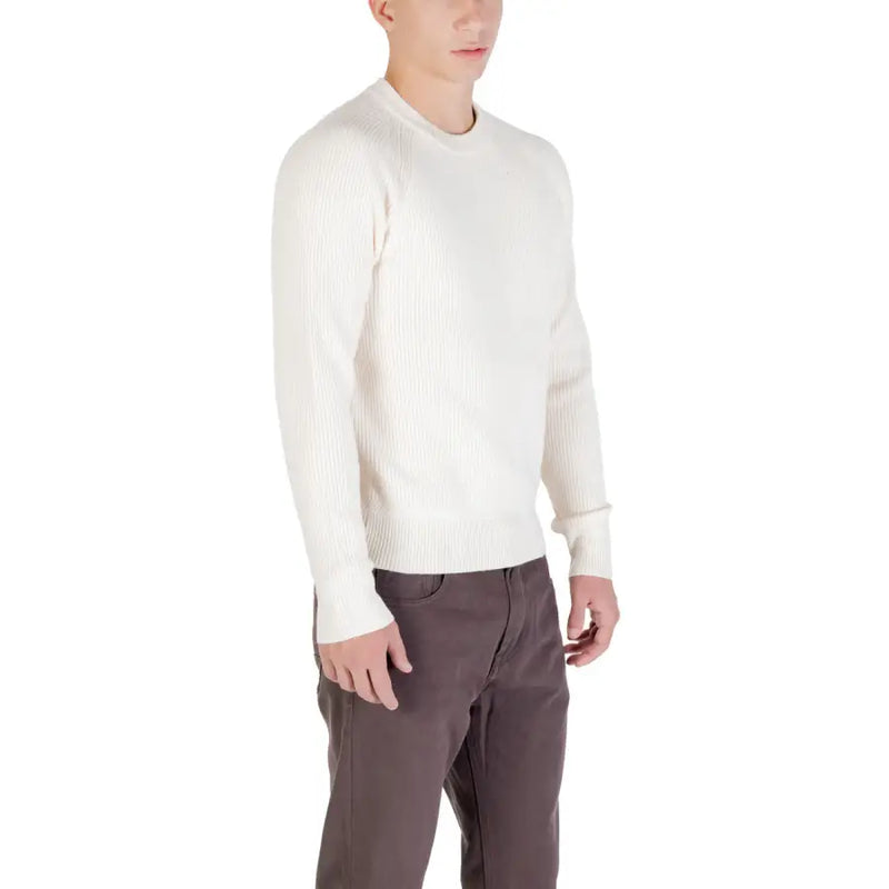 Cream-colored ribbed sweater with a crew neck and long sleeves.