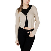 Beige ribbed knit cardigan with black inner lining and single pearl button closure in gold lurex button front style