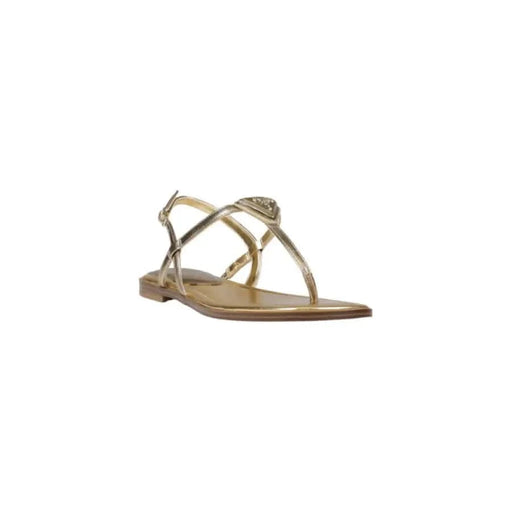 Gold-toned strappy sandal from Guess featuring a bow and buckle design for women