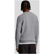 Gray cable-knit sweater displayed as a stylish and comfortable fall wardrobe staple