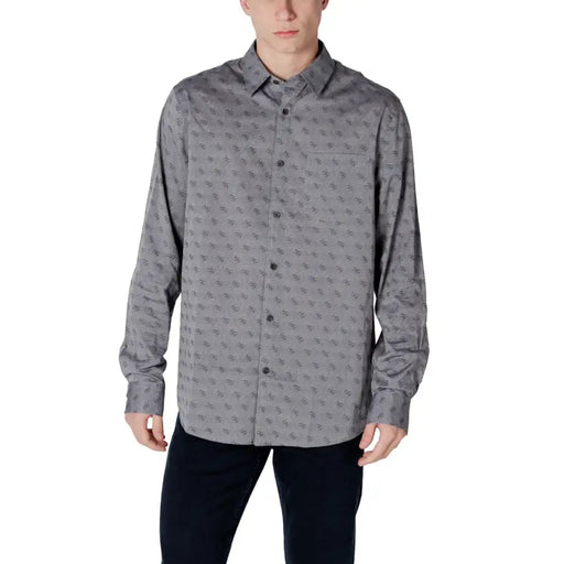 Gray patterned men’s long sleeved shirt made of fabric with a subtle repeating pattern of small dark symbols