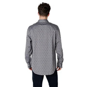 Gray patterned men’s long sleeved shirt featuring a subtle repeating pattern of small dark gray abstract shapes