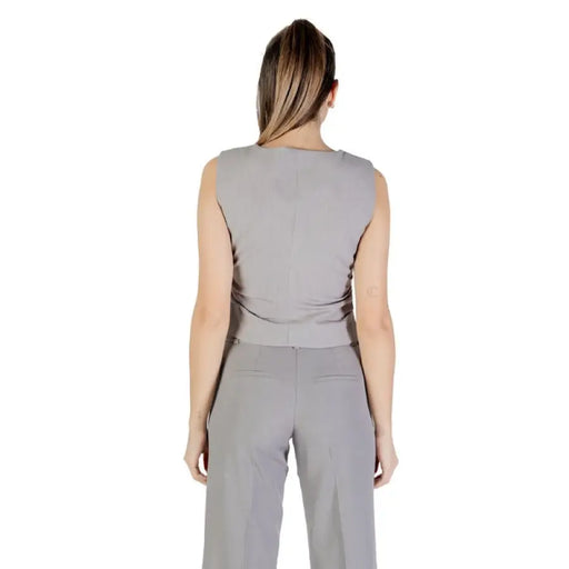 Gray sleeveless vest and pants set displayed in a stylish outfit for women