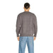 Gray sweater worn by a person seen from behind in Armani Exchange Men Knitwear