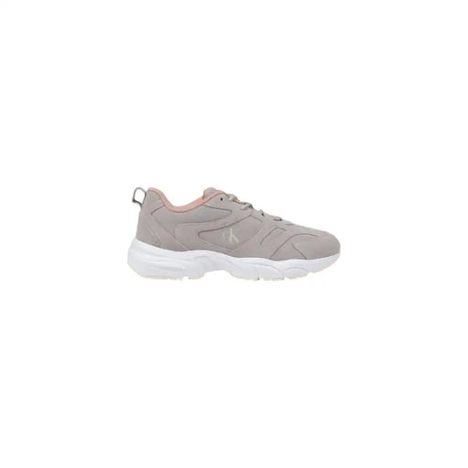 Gray and white athletic shoe designed for sports and activewear use