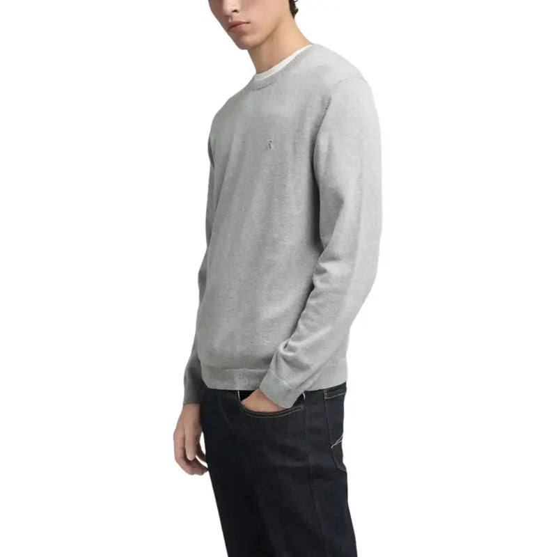 Light gray crewneck sweater with small embroidered logo on chest, made of cotton and polyester blend.