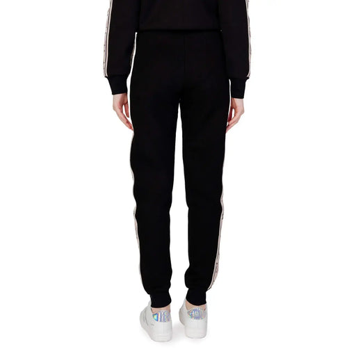Guess active Pantalon de jogging noir en coton pour femme, avec bandes latérales blanches et motif discret, idéal pour l'automne et l'hiver.