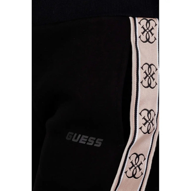 Noir Guess active Pantalon en coton pour femme avec bande latérale crème ornée de motifs à logos noirs entrelacés, idéal pour l'automne et l'hiver.