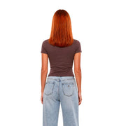 A woman wearing a Guess Active women brown viscose fitted short classic t shirt with light-wash denim jeans