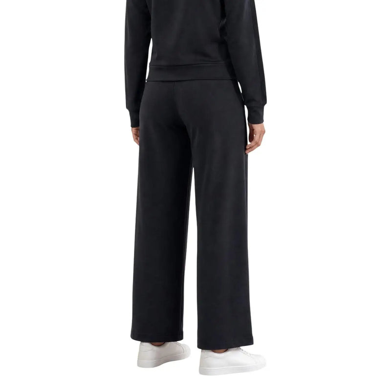 Guess Active Le pantalon Lyra Straight noir pour femme est un pantalon de survêtement à jambes larges, à la coupe décontractée et à la taille côtelée.