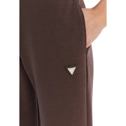 Brun Guess Active Pantalon long Olympe pour femme, confectionné dans un mélange de modal avec un écusson logo triangulaire sur la couture latérale.