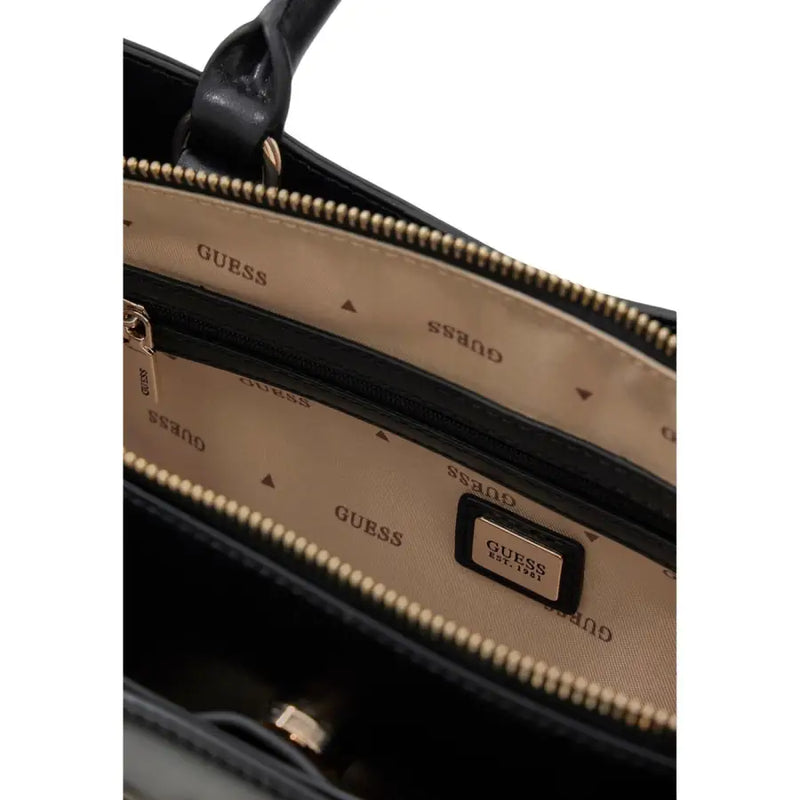 Black Guess handbag with gold-tone zippers shoulder strap pockets and branded interior lining