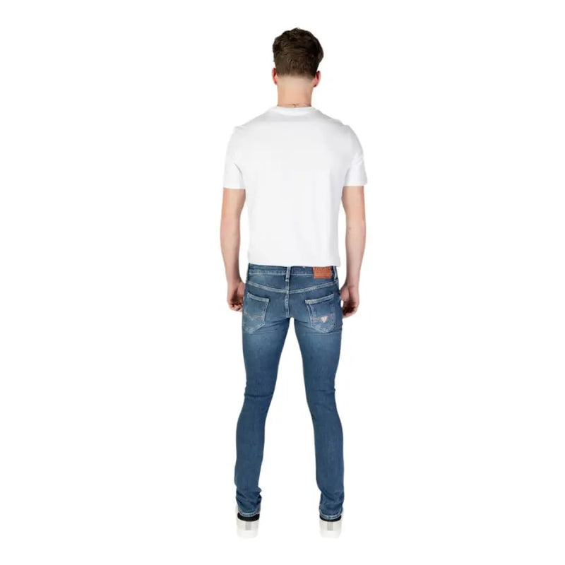 Guess men blue slim fit denim jeans with subtle distressed details from the spring summer collection