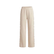 Guess Pantalon de survêtement beige à lacets pour femme, en mélange de modal, coupe large et détails discrets de texte vertical sur les coutures.