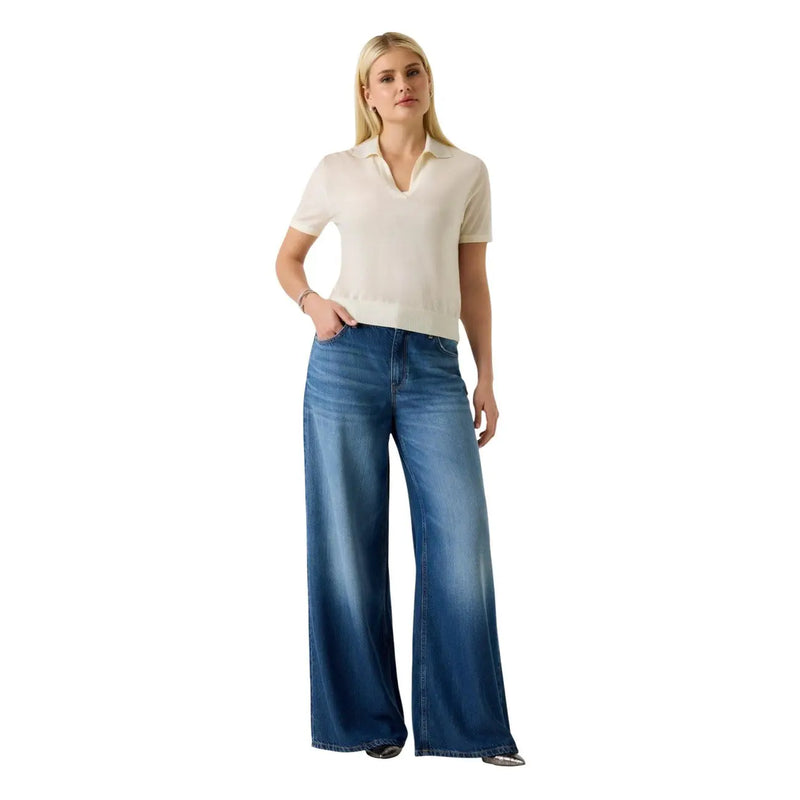 A pair of wide-leg blue denim jeans with faded wash and classic five-pocket design paired with guess women beige v neck wool polo tshirt short sleeve