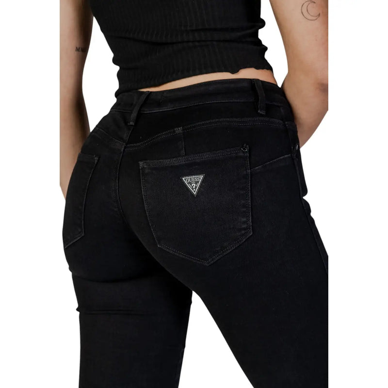 verso de Guess Jean noir en coton stretch pour femme, légèrement délavé, avec logo triangulaire sur la poche.