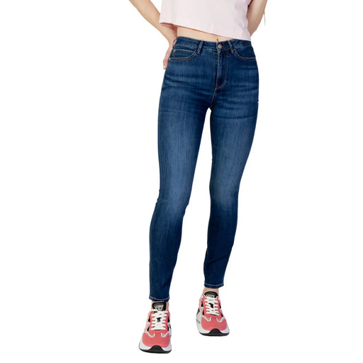Guess Jean slim taille haute en denim bleu foncé pour femme, mélange de coton, avec délavage subtil et coupe ajustée.