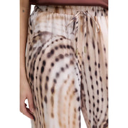 Guess Pantalon de jogging fluide Dalia pour femme, en lyocell beige, taille haute avec motif tie-dye beige et marron et ceinture à cordon de serrage.