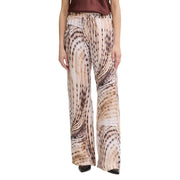Guess Pantalon de jogging fluide Dalia pour femme, en lyocell beige à jambes larges, orné d'un imprimé animal abstrait beige et marron fluide.