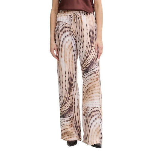 Guess Pantalon de jogging fluide Dalia pour femme, en lyocell beige à jambes larges, orné d'un imprimé animal abstrait beige et marron fluide.