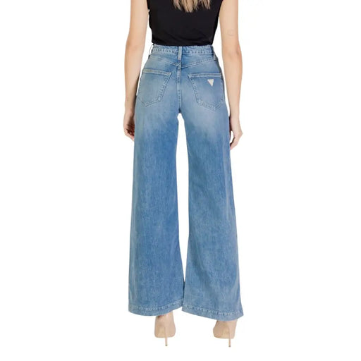 Women’s high-waisted wide-leg light blue jeans with zip and button closure by Guess