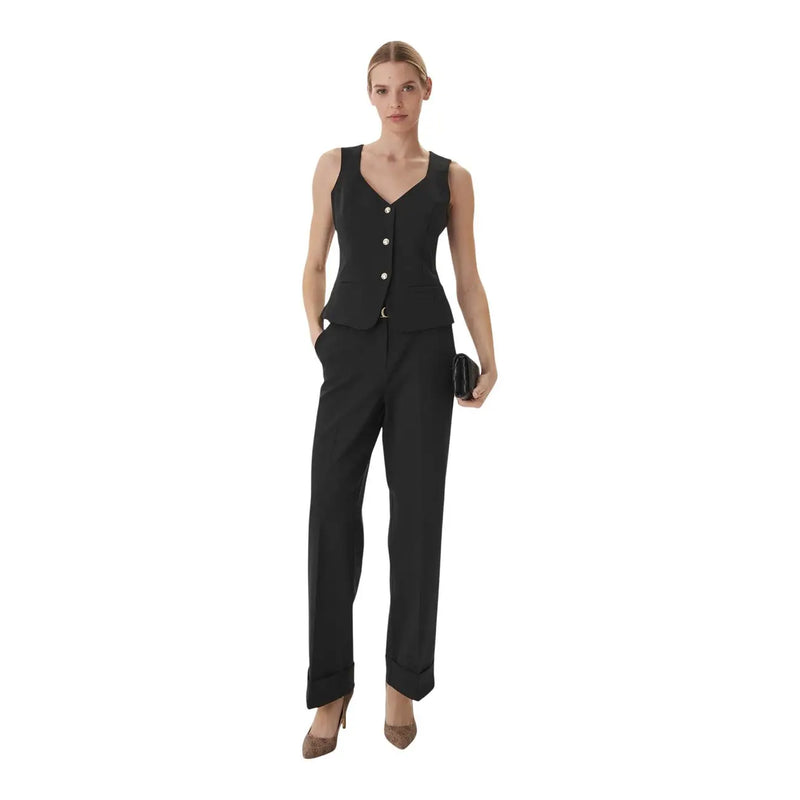 Gilet noir sans manches à boutons, col en V et coupe ajustée, porté avec guess pantalon structuré en crêpe avec ceinture pour femme