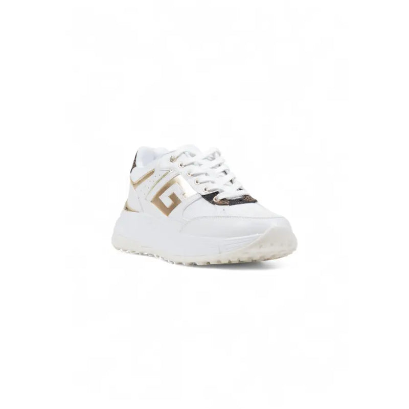 Guess women white leather platform sneakers with gold and black accents featuring a bold geometric logo on the side